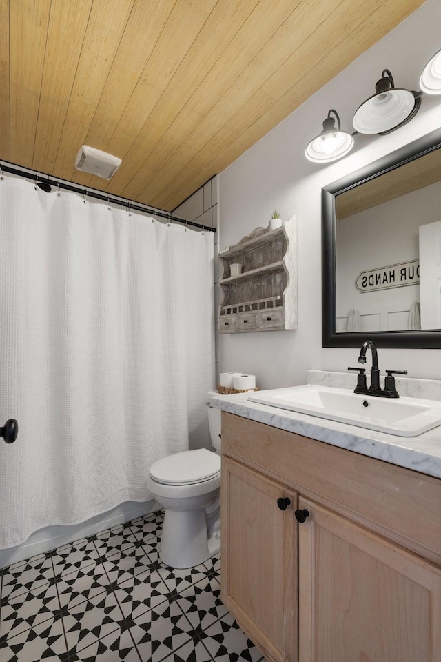 bathroom featuring toilet, wooden ceiling, vanity, and walk in shower