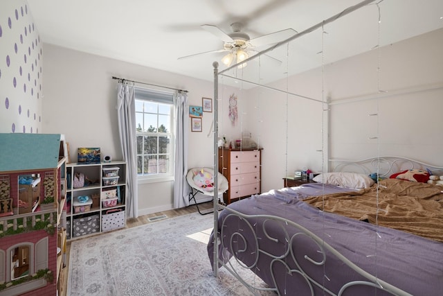 bedroom featuring hardwood / wood-style flooring and ceiling fan