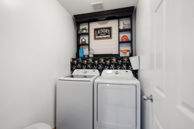 laundry area with separate washer and dryer