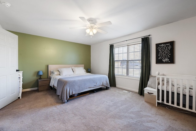 bedroom with ceiling fan and light colored carpet