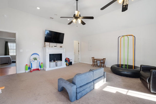 carpeted living room featuring vaulted ceiling and ceiling fan