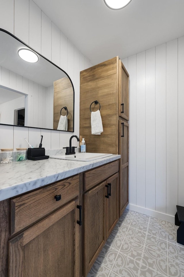 bathroom featuring tile patterned flooring and vanity