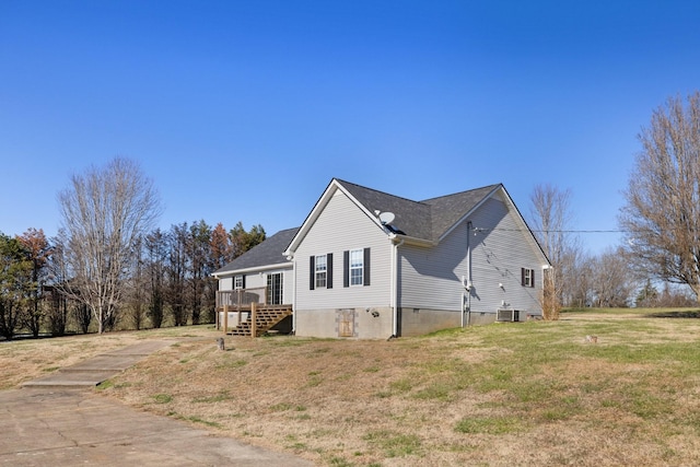 view of home's exterior with a yard, a deck, and central AC