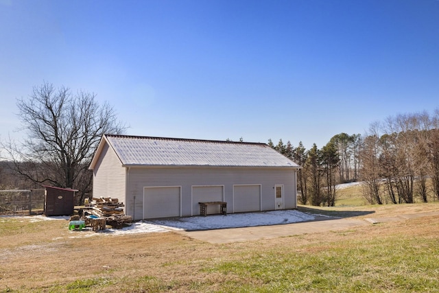 garage featuring a lawn