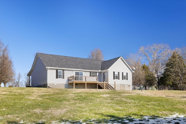 rear view of house featuring a lawn and a deck