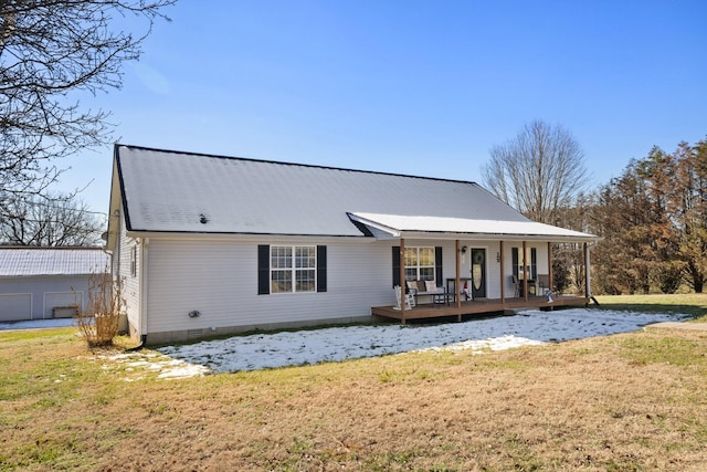 back of property featuring a yard and a porch