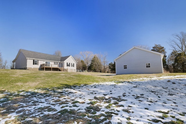 snow covered property featuring a lawn and a wooden deck