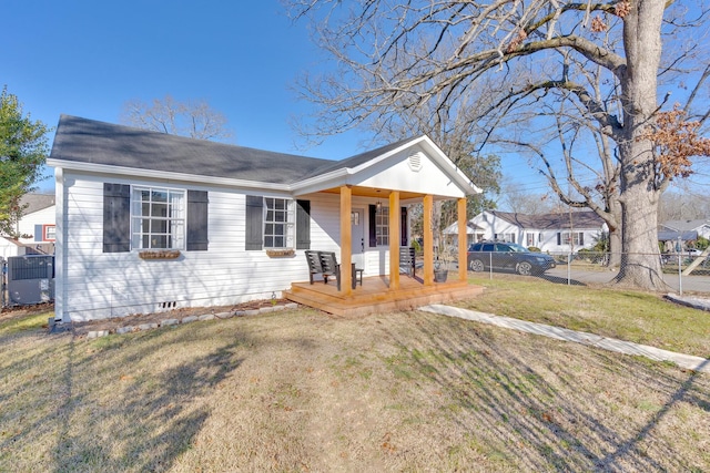 view of front of property featuring a front lawn, central AC unit, and a porch