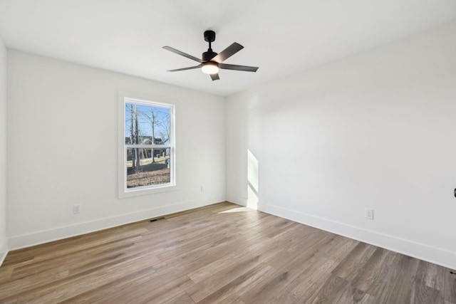 empty room featuring ceiling fan and hardwood / wood-style floors