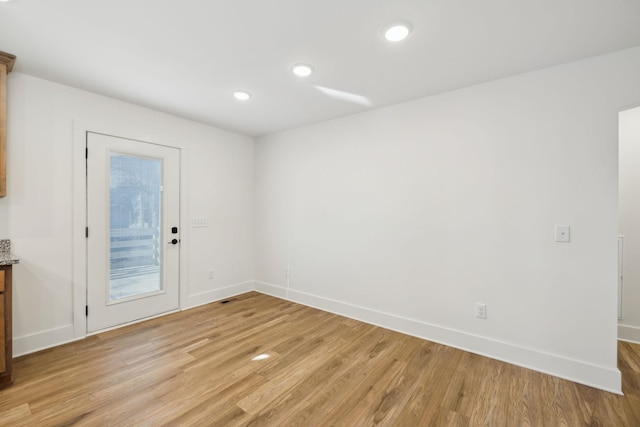 spare room with light hardwood / wood-style flooring