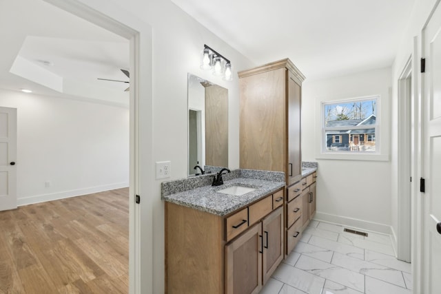 bathroom with ceiling fan and vanity