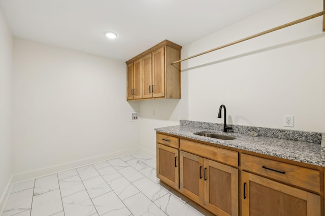 clothes washing area with washer hookup, cabinets, and sink