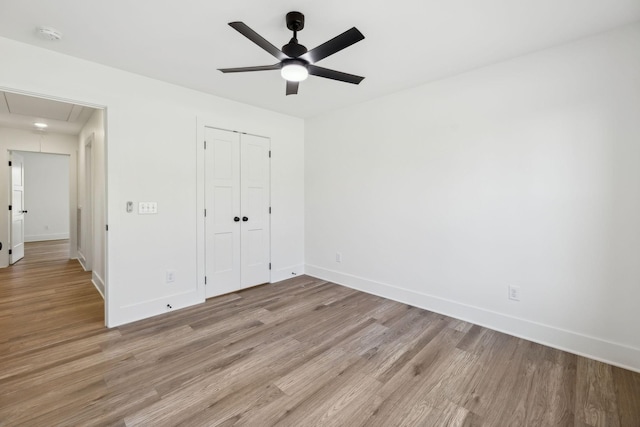 unfurnished bedroom featuring ceiling fan, a closet, and light hardwood / wood-style floors