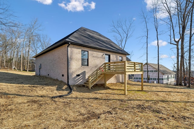 rear view of property featuring a yard and a wooden deck