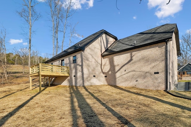 back of house featuring central AC, a deck, and a lawn