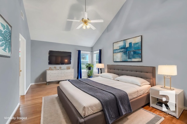 bedroom featuring ceiling fan, high vaulted ceiling, and light hardwood / wood-style floors