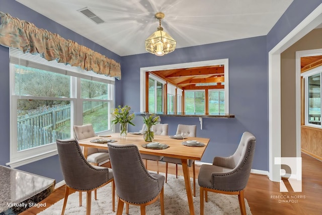 dining room featuring wood-type flooring and a chandelier