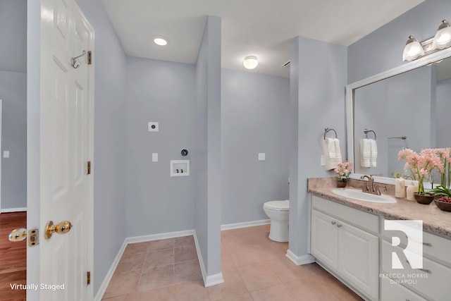 bathroom featuring vanity, tile patterned floors, and toilet