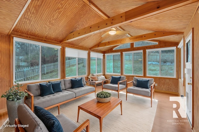 sunroom / solarium with lofted ceiling with beams, wooden ceiling, and ceiling fan