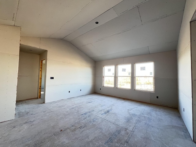 empty room featuring lofted ceiling