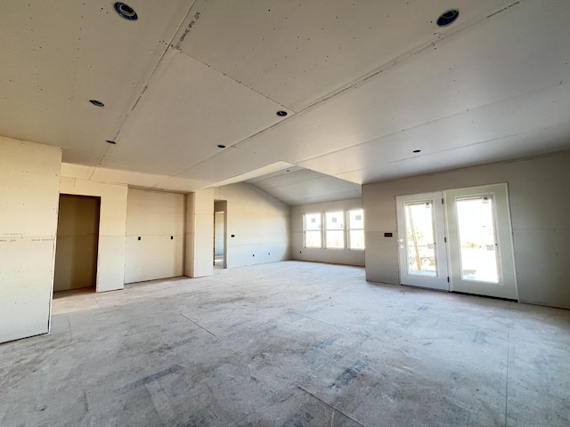 spare room with vaulted ceiling and plenty of natural light