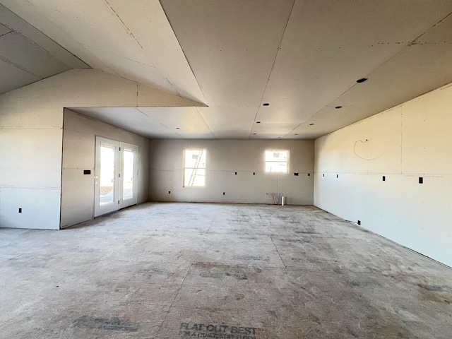 spare room with a healthy amount of sunlight and vaulted ceiling