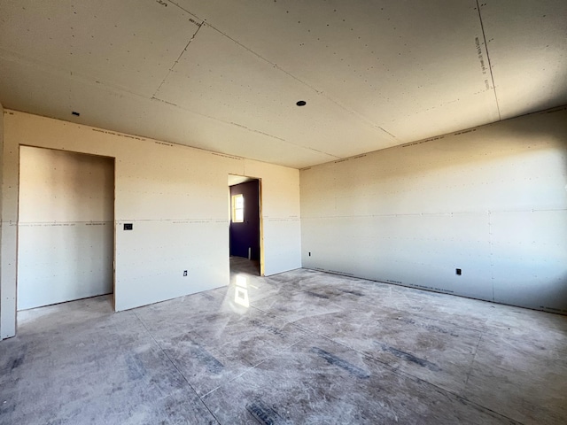 unfurnished room featuring concrete floors