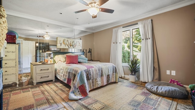 bedroom with a textured ceiling, ceiling fan, and crown molding