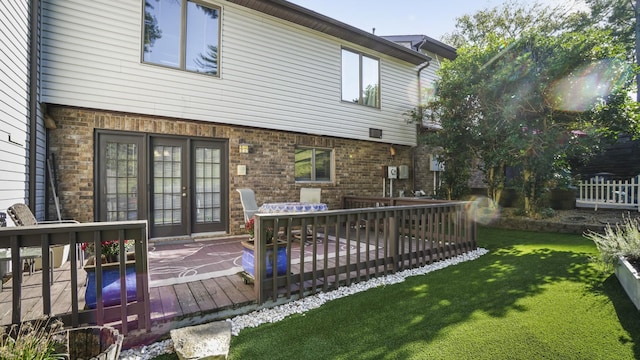 back of property with a lawn and a wooden deck