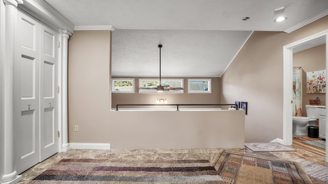 interior space featuring ceiling fan, ornamental molding, a textured ceiling, and vaulted ceiling