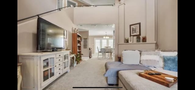 carpeted bedroom featuring a notable chandelier