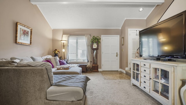 living room featuring vaulted ceiling with beams and light colored carpet