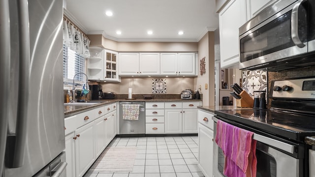 kitchen with white cabinets, sink, light tile patterned floors, and stainless steel appliances