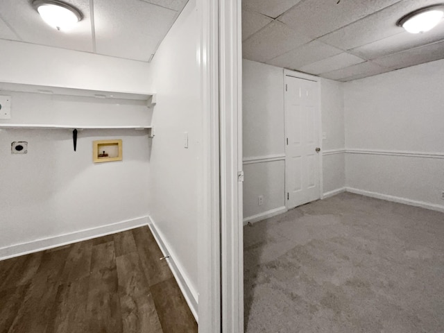 basement featuring a drop ceiling and hardwood / wood-style flooring