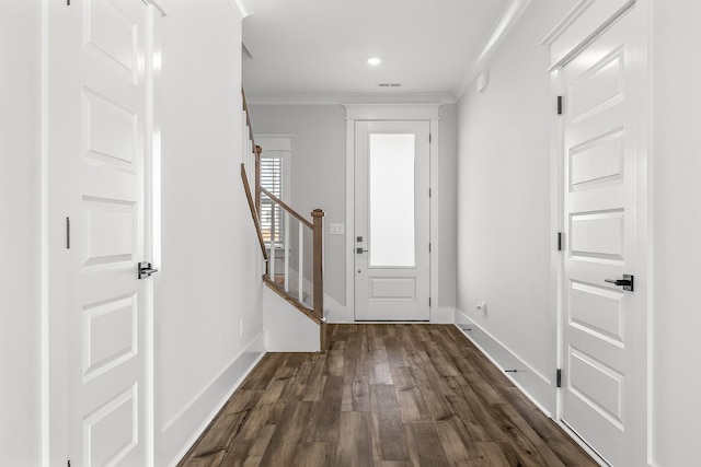 entryway featuring ornamental molding and dark hardwood / wood-style flooring