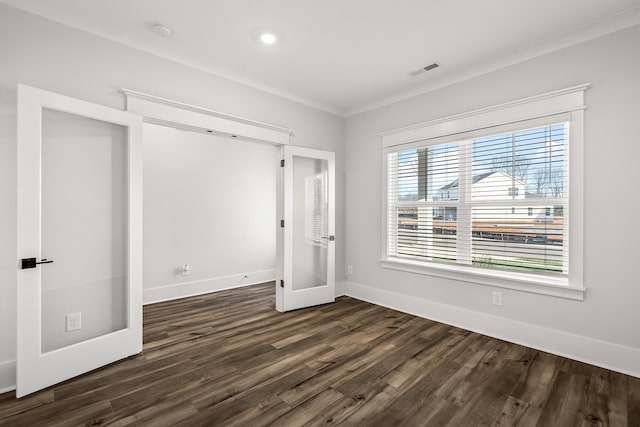 unfurnished bedroom featuring crown molding and dark wood-type flooring