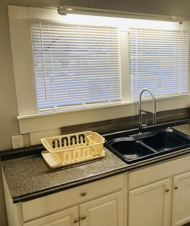 interior details with white cabinets and sink