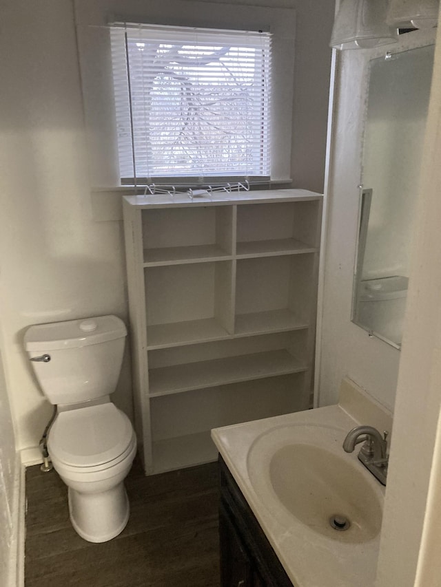 bathroom featuring hardwood / wood-style floors, vanity, and toilet