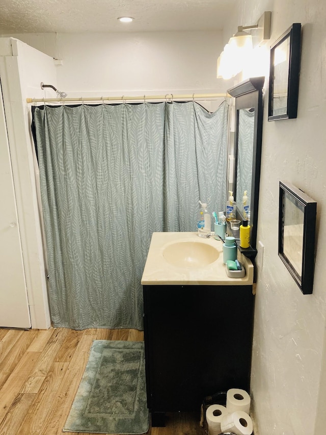 bathroom with hardwood / wood-style floors and vanity