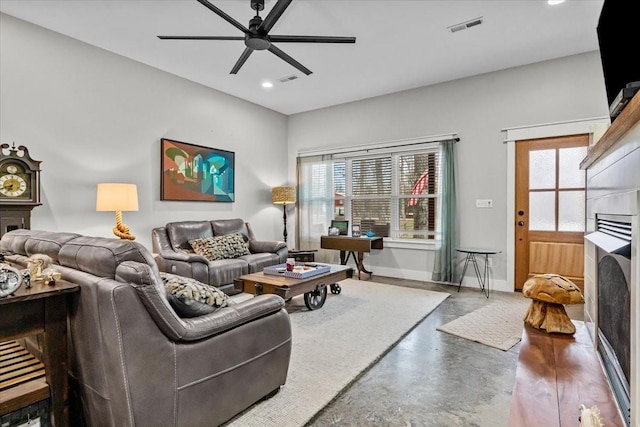 living room featuring concrete floors and ceiling fan