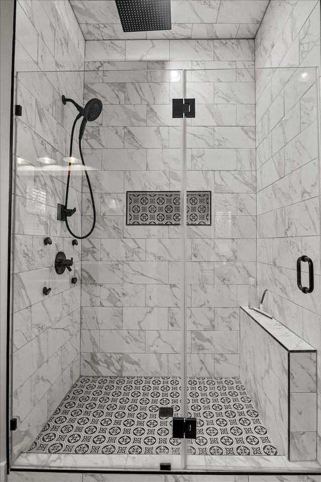 bathroom featuring a shower with door