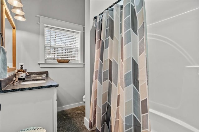 bathroom with vanity, curtained shower, and toilet