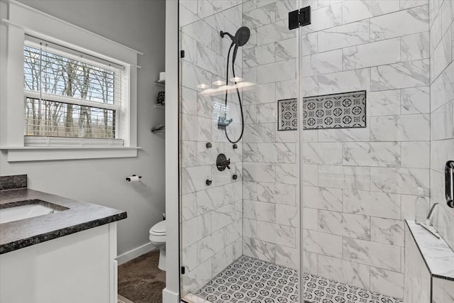 bathroom featuring walk in shower, vanity, and toilet