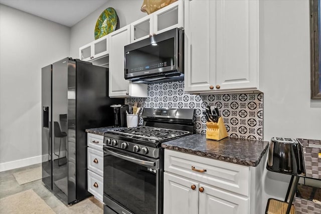 kitchen featuring appliances with stainless steel finishes, backsplash, and white cabinetry