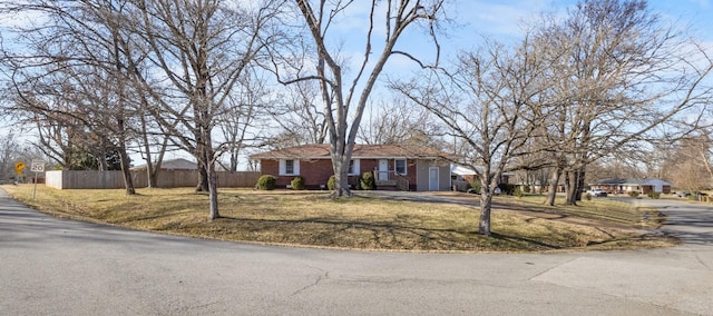 single story home featuring a front lawn