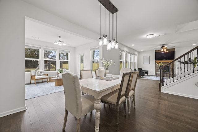 dining room with ceiling fan and dark hardwood / wood-style flooring