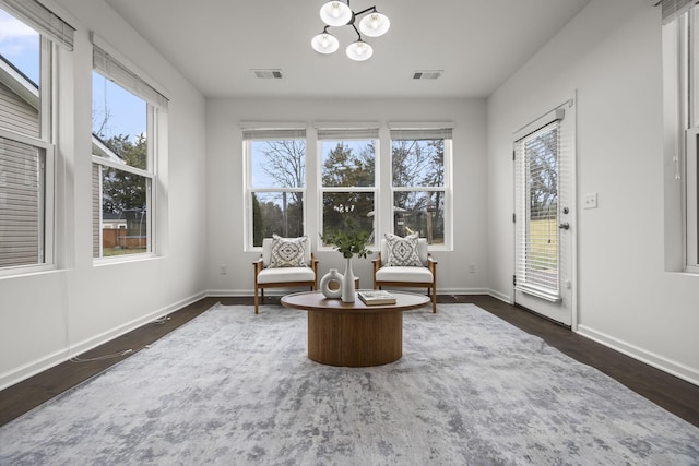 sitting room featuring a notable chandelier and dark hardwood / wood-style flooring