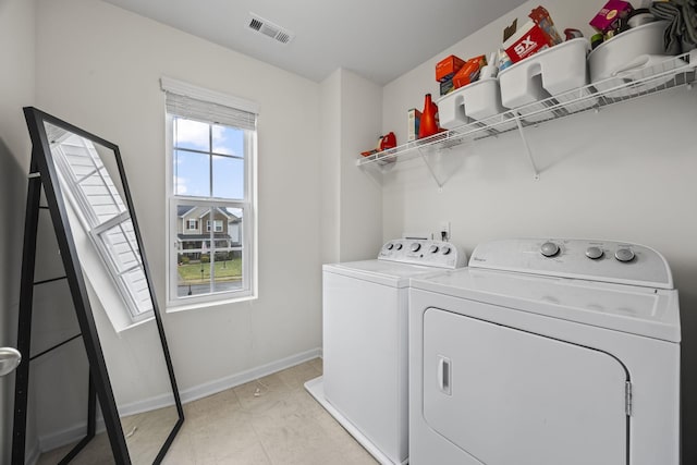 clothes washing area featuring washing machine and dryer