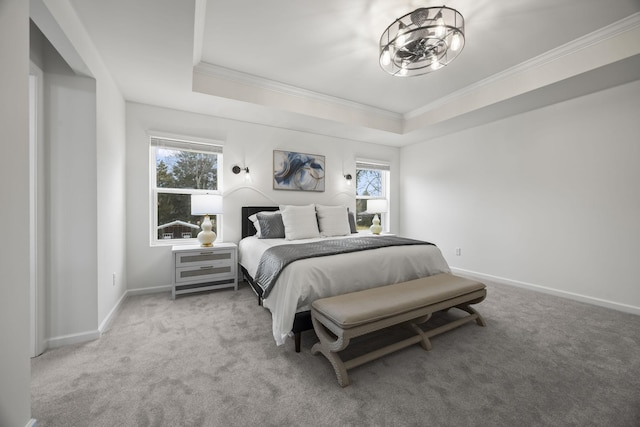 carpeted bedroom featuring crown molding, a notable chandelier, and a tray ceiling