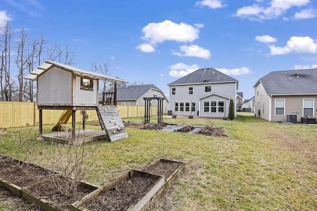 exterior space with central AC unit, a yard, and an outdoor structure